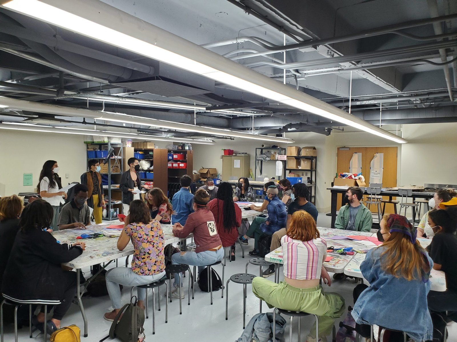 Workshop attendees gather around three different tables in Studio A at UMD.