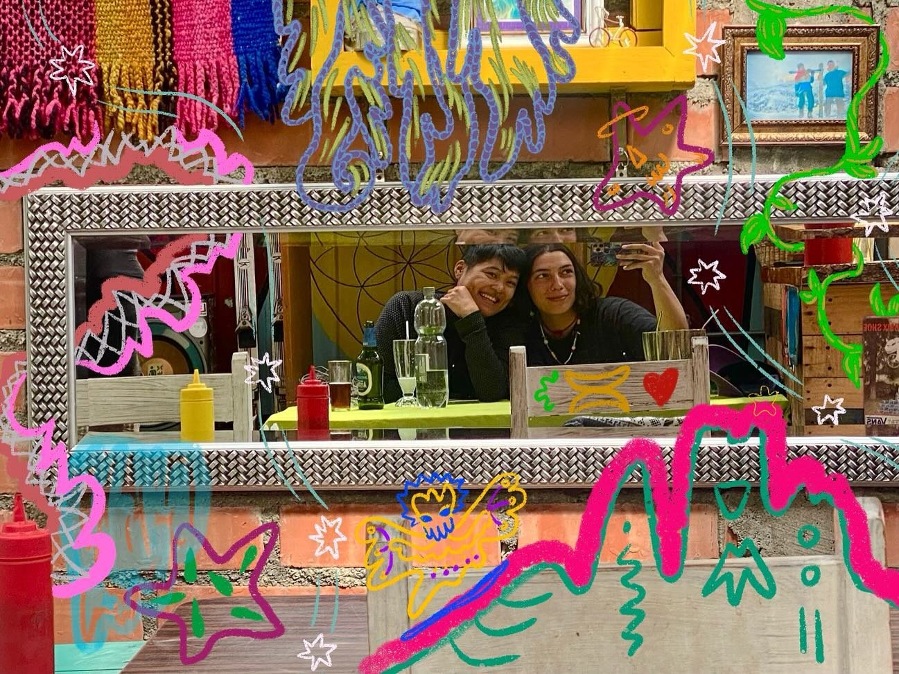 Co-founders Camila and Ellie take a selfie in a mirror. There are colorful illustrations overlayed on top of the photo.